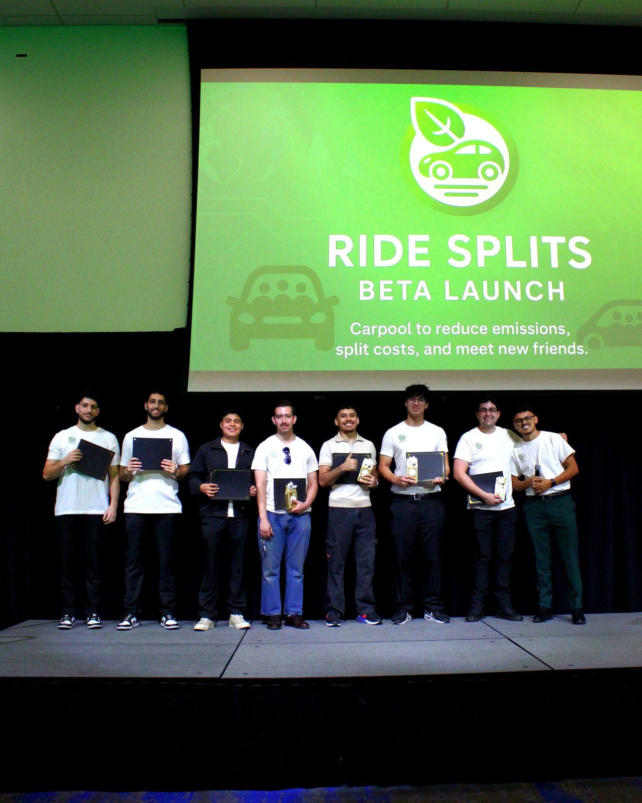 The team lined up on stage under a Ride Splits Beta Launch slide