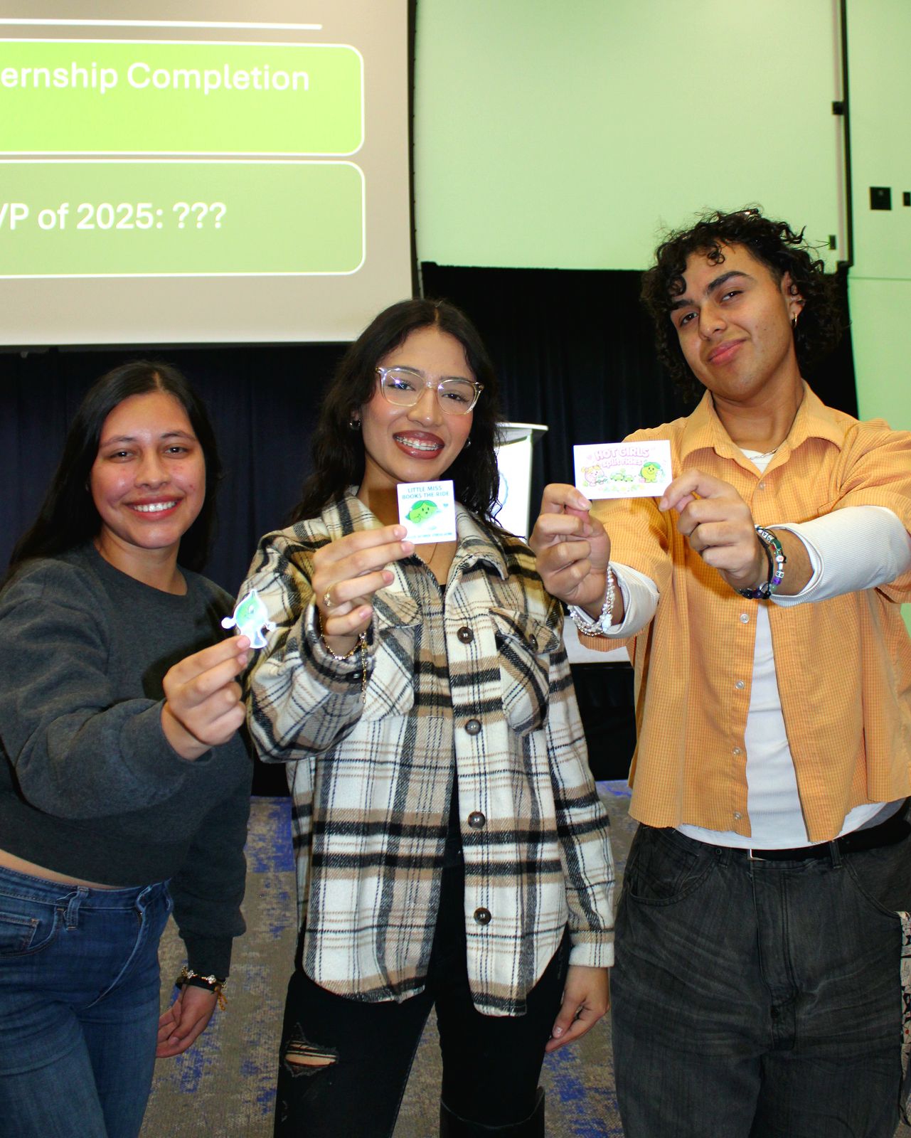 Three guests holding up Ride Splits stickers and cards